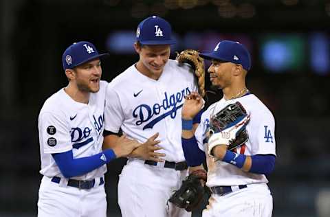 LOS ANGELES, CA - SEPTEMBER 11: Mookie Betts #50 of the Los Angeles Dodgers celebrate with Trea Turner #6 and Corey Seager #5 after defeating the San Diego Padres 5-4 at Dodger Stadium on September 11, 2021 in Los Angeles, California. (Photo by Kevork Djansezian/Getty Images)