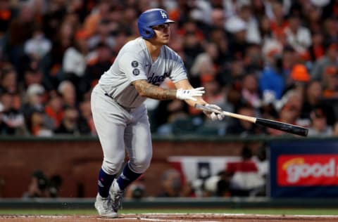 SAN FRANCISCO, CALIFORNIA - OCTOBER 09: Julio Urias #7 of the Los Angeles Dodgers hits an RBI single in the second inning against the San Francisco Giants during Game 2 of the National League Division Series at Oracle Park on October 09, 2021 in San Francisco, California. (Photo by Ezra Shaw/Getty Images)