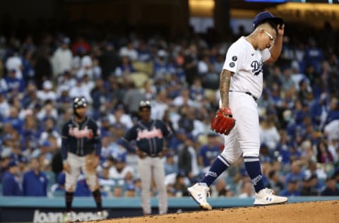 LOS ANGELES, CALIFORNIA - OCTOBER 20: Julio Urias #7 of the Los Angeles Dodgers reacts after giving up a triple by Eddie Rosario #8 of the Atlanta Braves during the third inning of Game Four of the National League Championship Series at Dodger Stadium on October 20, 2021 in Los Angeles, California. (Photo by Sean M. Haffey/Getty Images)