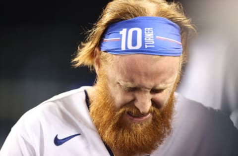 LOS ANGELES, CALIFORNIA - OCTOBER 20: Justin Turner #10 of the Los Angeles Dodgers reacts after suffering an injury during the seventh inning of Game Four of the National League Championship Series against the Atlanta Braves at Dodger Stadium on October 20, 2021 in Los Angeles, California. (Photo by Ronald Martinez/Getty Images)