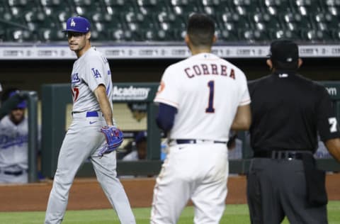 HOUSTON, TEXAS - JULY 28: Joe Kelly #17 of the Los Angeles Dodgers has words with Carlos Correa #1 of the Houston Astros as he walks towards the dugout at Minute Maid Park on July 28, 2020 in Houston, Texas. Both benches would empty after Kelly had thrown high inside pitches at Correa, Bregman and Guriel in the sixth inning. (Photo by Bob Levey/Getty Images)