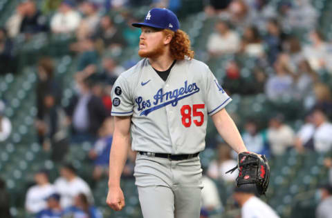 SEATTLE, WASHINGTON - APRIL 19: Dustin May #85 of the Los Angeles Dodgers reacts after giving up a two-run home run to Jose Marmolejos #26 of the Seattle Mariners during the first inning at T-Mobile Park on April 19, 2021 in Seattle, Washington. (Photo by Abbie Parr/Getty Images)