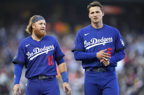 SAN FRANCISCO, CALIFORNIA - SEPTEMBER 05: Justin Turner #10 and Corey Seager #5 of the Los Angeles Dodgers looks on waiting for their gloves and hats at the end of the top of the fifth inning against the San Francisco Giants at Oracle Park on September 05, 2021 in San Francisco, California. (Photo by Thearon W. Henderson/Getty Images)