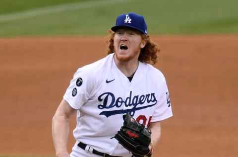 LOS ANGELES, CALIFORNIA - APRIL 25: Dustin May #85 of the Los Angeles Dodgers reacts to his pitch during the fifth inning against the San Diego Padres at Dodger Stadium on April 25, 2021 in Los Angeles, California. (Photo by Harry How/Getty Images)