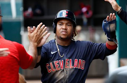 ARLINGTON, TEXAS - OCTOBER 03: Jose Ramirez #11 of the Cleveland Indians is greeted by teammates after scoring a run in the third inning against the Texas Rangers at Globe Life Field on October 03, 2021 in Arlington, Texas. (Photo by Tim Warner/Getty Images)