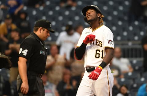 PITTSBURGH, PA - OCTOBER 03: Oneil Cruz #61 of the Pittsburgh Pirates reacts as he crosses home plate after hitting a two run home run for his first Major League home run in the ninth inning during the game against the Cincinnati Reds at PNC Park on October 3, 2021 in Pittsburgh, Pennsylvania. (Photo by Justin Berl/Getty Images)