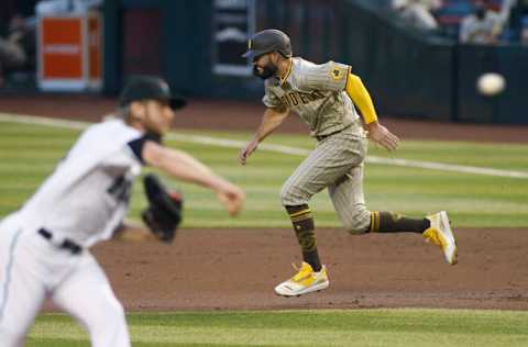 PHOENIX, ARIZONA - AUGUST 14: Eric Hosmer #30 of the San Diego Padres attempts to steal second base as pitcher Merrill Kelly #29 of the Arizona Diamondbacks throws a pitch during the second inning of the MLB game at Chase Field on August 14, 2020 in Phoenix, Arizona. (Photo by Ralph Freso/Getty Images)