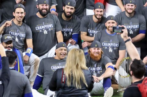 ARLINGTON, TEXAS - OCTOBER 27: Justin Turner #10 of the Los Angeles Dodgers and manager Dave Roberts of the Los Angeles Dodgers pose for a photo with their teammates after the teams 3-1 victory against the Tampa Bay Rays in Game Six to win the 2020 MLB World Series at Globe Life Field on October 27, 2020 in Arlington, Texas. (Photo by Tom Pennington/Getty Images)