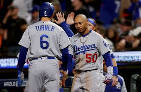 SAN FRANCISCO, CALIFORNIA - OCTOBER 09: Trea Turner #6 and Mookie Betts #50 of the Los Angeles Dodgers celebrate after Turner scored a run in the sixth inning against the San Francisco Giants during Game 2 of the National League Division Series at Oracle Park on October 09, 2021 in San Francisco, California. (Photo by Harry How/Getty Images)