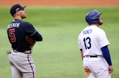 ARLINGTON, TEXAS - OCTOBER 17: Freddie Freeman #5 of the Atlanta Braves and Max Muncy #13 of the Los Angeles Dodgers await the result of a video review during the third inning in Game Six of the National League Championship Series at Globe Life Field on October 17, 2020 in Arlington, Texas. (Photo by Tom Pennington/Getty Images)