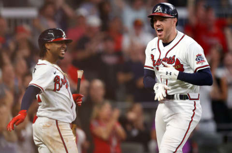 ATLANTA, GEORGIA - OCTOBER 12: Freddie Freeman #5 of the Atlanta Braves celebrates with Ozzie Albies #1 after hitting a home run during the eighth inning against the Milwaukee Brewers in game four of the National League Division Series at Truist Park on October 12, 2021 in Atlanta, Georgia. (Photo by Todd Kirkland/Getty Images)