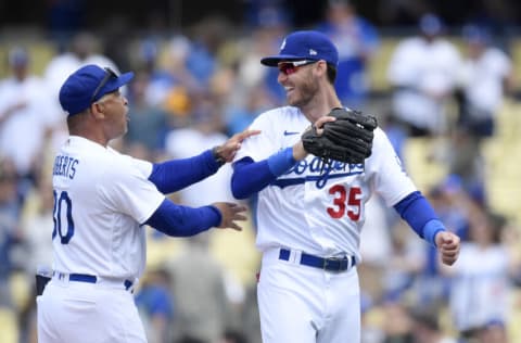 LOS ANGELES, CA - APRIL 20: Manager Dave Roberts #30 of the Los Angeles Dodgers and Cody Bellinger #35 celebrate after defeating the Atlanta Braves 5-1 at Dodger Stadium on April 20, 2022 in Los Angeles, California. (Photo by Kevork Djansezian/Getty Images)