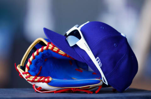 DENVER, CO - APRIL 8: A detail of the glove, hat and sunglasses used by Mookie Betts #50 of the Los Angeles Dodgers in the fourth inning during a game against the Colorado Rockies on Opening Day at Coors Field on April 8, 2022 in Denver, Colorado. (Photo by Justin Edmonds/Getty Images)