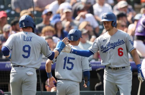 DENVER, COLORADO - SEPTEMBER 23: Gavin Lux #9 and Austin Barnes #15 of the Los Angeles Dodgers are congratulated by Trea Turner #6 after scoring on a Corey Seager 2 RBI single against the Colorado Rockies in the second inning at Coors Field on September 23, 2021 in Denver, Colorado. (Photo by Matthew Stockman/Getty Images)