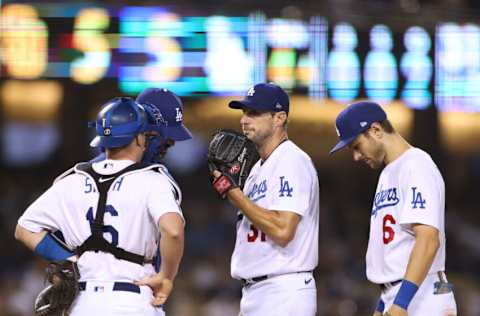 LOS ANGELES, CALIFORNIA - SEPTEMBER 29: Max Scherzer #31 of the Los Angeles Dodgers reacts as he receives the visit from Mark Prior #99, Trea Turner #6 and Will Smith #16 after an error from Corey Seager #5, allowing Wil Myers #5 of the San Diego Padres to score to tie the game 5-5, during the fourth inning at Dodger Stadium on September 29, 2021 in Los Angeles, California. (Photo by Harry How/Getty Images)