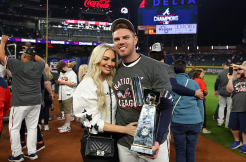 ATLANTA, GEORGIA - OCTOBER 23: Freddie Freeman #5 of the Atlanta Braves hugs his wife Chelsea following Game Six of the National League Championship Series against the Los Angeles Dodgers at Truist Park on October 23, 2021 in Atlanta, Georgia. The Braves defeated the Dodgers 4-2 to advance to the 2021 World Series. (Photo by Kevin C. Cox/Getty Images)