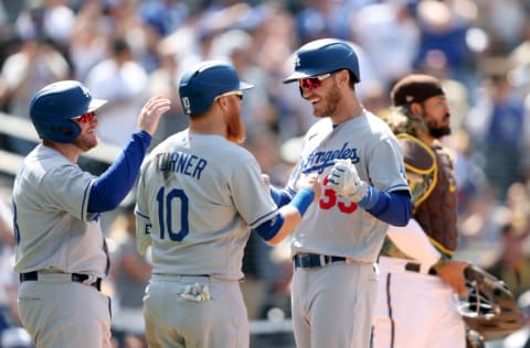 SAN DIEGO, CALIFORNIA - APRIL 24: Jorge Alfaro #38 of the San Diego Padres looks on as Justin Turner #10 and Max Muncy #13 congratulate Cody Bellinger #35 of the Los Angeles Dodgers after his three-run homerun during the fifth inning of a game at PETCO Park on April 24, 2022 in San Diego, California. (Photo by Sean M. Haffey/Getty Images)