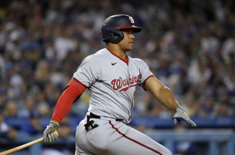 LOS ANGELES, CA - JULY 25: Juan Soto #22 of the Washington Nationals hits a two-run triple to score Cesar Hernandez #1 and Victor Robles #16 against starting pitcher Tony Gonsolin #26 of the Los Angeles Dodgers during the fifth inning at Dodger Stadium on July 25, 2022 in Los Angeles, California. (Photo by Kevork Djansezian/Getty Images)