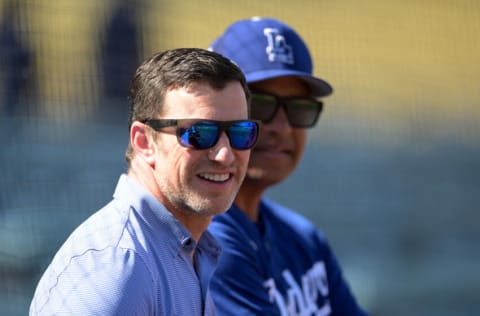 LOS ANGELES, CA - APRIL 05: Andrew Friedman, President of Baseball Operations and manager Dave Roberts #30 of the Los Angeles Dodgers talk on the field before a preseason game against the Los Angeles Angels at Dodger Stadium on April 5, 2022 in Los Angeles, California. (Photo by Jayne Kamin-Oncea/Getty Images)