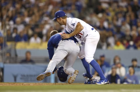 LOS ANGELES, CALIFORNIA - JULY 08: Ian Happ #8 of the Chicago Cubs collides with Tyler Anderson #31 of the Los Angeles Dodgers as he caught in a run down at home plate during the fifth inning at Dodger Stadium on July 08, 2022 in Los Angeles, California. (Photo by Michael Owens/Getty Images)