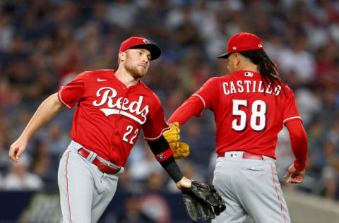 NEW YORK, NEW YORK - JULY 14: Brandon Drury #22 of the Cincinnati Reds is congratulated by teammate Luis Castillo #58 after Drury fielded a hit by DJ LeMahieu of the New York Yankees for the out in the sixth inning at Yankee Stadium on July 14, 2022 in the Bronx borough of New York City. (Photo by Elsa/Getty Images)