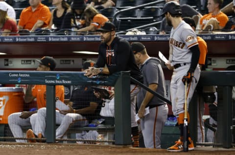 PHOENIX, ARIZONA - JULY 27: Manager Gabe Kapler #19 of the San Francisco Giants (center) looks on during the eighth inning against the Arizona Diamondbacks at Chase Field on July 27, 2022 in Phoenix, Arizona. The Diamondbacks beat the Giants 5-3. (Photo by Chris Coduto/Getty Images)