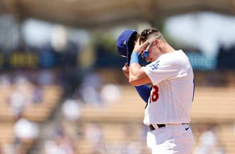 LOS ANGELES, CALIFORNIA - JULY 27: Jake Lamb #18 of the Los Angeles Dodgers adjusts his hat while on first base against the Washington Nationals during the seventh inning at Dodger Stadium on July 27, 2022 in Los Angeles, California. (Photo by Michael Owens/Getty Images)