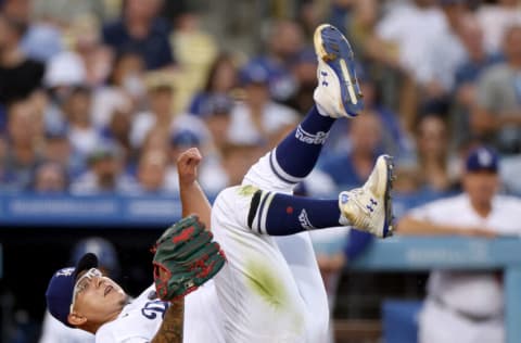 LOS ANGELES, CALIFORNIA - AUGUST 09: Julio Urias #7 of the Los Angeles Dodgers reacts after his throw to first base on an infield RBI single from Gilberto Celestino #67 of the Minnesota Twins, for a 1-1 tie, during the second inning at Dodger Stadium on August 09, 2022 in Los Angeles, California. (Photo by Harry How/Getty Images)