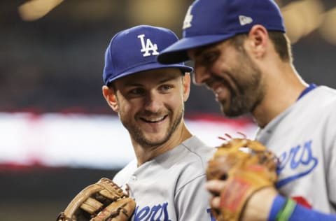 MIAMI, FLORIDA - AUGUST 27: Trea Turner #6 (L) of the Los Angeles Dodgers talks to teammate Chris Taylor #3 after the eighth inning against the Miami Marlins at loanDepot park on August 27, 2022 in Miami, Florida. (Photo by Bryan Cereijo/Getty Images)