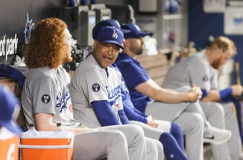 MIAMI, FLORIDA - AUGUST 27: Manager Dave Roberts of the Los Angeles Dodgers talks to pitcher Dustin May #85 after taking him out of the game against the Miami Marlins at loanDepot park on August 27, 2022 in Miami, Florida. (Photo by Bryan Cereijo/Getty Images)