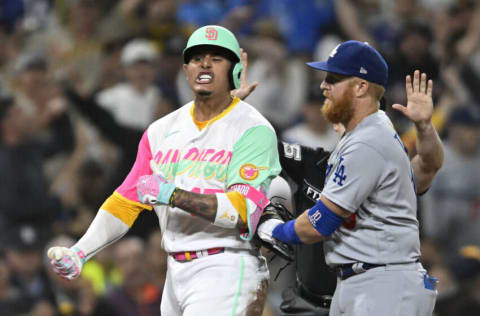 SAN DIEGO, CA - SEPTEMBER 9: Manny Machado #13 of the San Diego Padres celebrates after hitting an RBI triple as Justin Turner #10 of the Los Angeles Dodgers looks on during the fifth inning of a baseball game at Petco Park on September 9, 2022 in San Diego, California. (Photo by Denis Poroy/Getty Images)