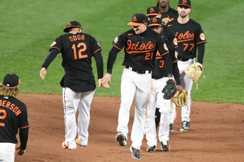 Austin Hays #21 and Rougned Odor #12 of the Baltimore Orioles (Photo by Mitchell Layton/Getty Images)