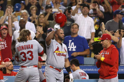 LOS ANGELES, CALIFORNIA - SEPTEMBER 23: Albert Pujols #5 of the St. Louis Cardinals tips his hat to fans after hitting his 700th career homerun, his second homerun of the game, to take a 5-0 lead over the Los Angeles Dodgers during the fourth inning at Dodger Stadium on September 23, 2022 in Los Angeles, California. (Photo by Harry How/Getty Images)