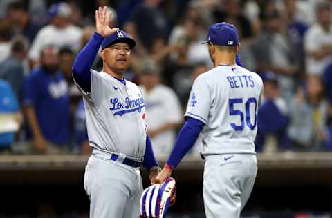 SAN DIEGO, CALIFORNIA - SEPTEMBER 29: Manager Dave Roberts congratulats Mookie Betts #50 of the Los Angeles Dodgers after defeating the San Diego Padres 5-2 in a game at PETCO Park on September 29, 2022 in San Diego, California. (Photo by Sean M. Haffey/Getty Images)