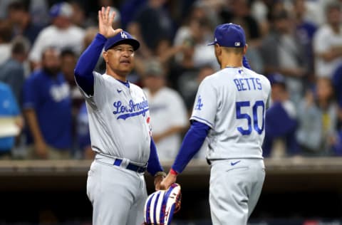 SAN DIEGO, CALIFORNIA - SEPTEMBER 29: Manager Dave Roberts congratulats Mookie Betts #50 of the Los Angeles Dodgers after defeating the San Diego Padres 5-2 in a game at PETCO Park on September 29, 2022 in San Diego, California. (Photo by Sean M. Haffey/Getty Images)