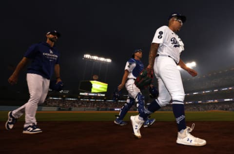 LOS ANGELES, CALIFORNIA - OCTOBER 11: Julio Urias #7 and Austin Barnes #15 of the Los Angeles Dodgers walk to the dugout before game one of the National League Division Series against the San Diego Padres at Dodger Stadium on October 11, 2022 in Los Angeles, California. (Photo by Harry How/Getty Images)