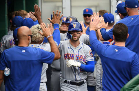 PITTSBURGH, PA - SEPTEMBER 07: Tyler Naquin #25 of the New York Mets celebrates with teammates in the dugout after hitting a three run home run in the fourth inning during Game One of a doubleheader against the Pittsburgh Pirates at PNC Park on September 7, 2022 in Pittsburgh, Pennsylvania. (Photo by Justin Berl/Getty Images)