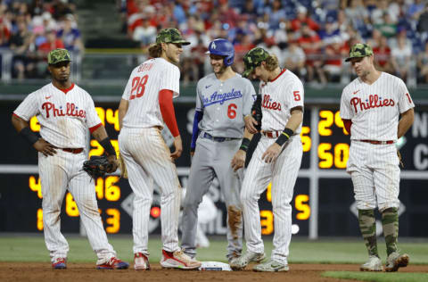 PHILADELPHIA, PENNSYLVANIA - MAY 21: Trea Turner #6 of the Los Angeles Dodgers (C) speaks with Alec Bohm #28 and Bryson Stott #5 of the Philadelphia Phillies during the seventh inning at Citizens Bank Park on May 21, 2022 in Philadelphia, Pennsylvania. (Photo by Tim Nwachukwu/Getty Images)