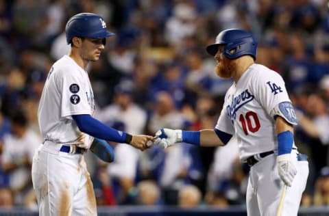 LOS ANGELES, CALIFORNIA - OCTOBER 11: Trea Turner #6 of the Los Angeles Dodgers fist bumps Justin Turner #10 after scoring in the third inning in game one of the National League Division Series against the San Diego Padres at Dodger Stadium on October 11, 2022 in Los Angeles, California. (Photo by Harry How/Getty Images)