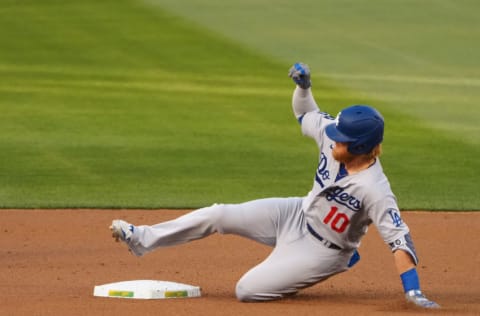 Apr 6, 2021; Oakland, California, USA; Los Angeles Dodgers designated hitter Justin Turner (10) slides safely to second base on a double against the Oakland Athletics during the first inning at RingCentral Coliseum. Mandatory Credit: Kelley L Cox-USA TODAY Sports