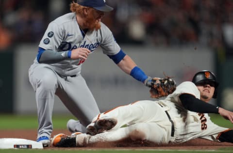 Oct 9, 2021; San Francisco, California, USA; San Francisco Giants first baseman Wilmer Flores (41) is tagged out at third base by Los Angeles Dodgers third baseman Justin Turner (10) in the sixth inning during game two of the 2021 NLDS at Oracle Park. Mandatory Credit: Neville E. Guard-USA TODAY Sports