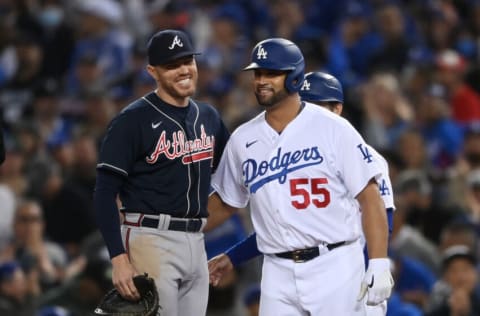 Oct 20, 2021; Los Angeles, California, USA; Los Angeles Dodgers first baseman Albert Pujols (55) smiles after being safe at first against Atlanta Braves first baseman Freddie Freeman (5) in the seventh inning during game four of the 2021 NLCS at Dodger Stadium. Mandatory Credit: Jayne Kamin-Oncea-USA TODAY Sports