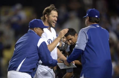 April 14, 2017; Los Angeles, CA, USA; Los Angeles Dodgers starting pitcher Clayton Kershaw (22), pitching coach Rick Honeycutt (40) and manager Dave Roberts (30) celebrate the 7-1 victory against the Arizona Diamondbacks at Dodger Stadium. Mandatory Credit: Gary A. Vasquez-USA TODAY Sports