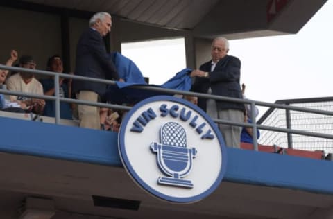 May 3, 2017; Los Angeles, CA, USA; Sandy Koufax (left) and Tommy Lasorda unveil the name of Los Angeles Dodgers retired broadcaster Vin Scully on the Dodgers Ring of Honor during an MLB game against the San Francisco Giants at Dodger Stadium. Mandatory Credit: Kirby Lee-USA TODAY Sports