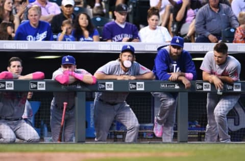 May 13, 2017; Denver, CO, USA; Members of the Los Angeles Dodgers hang on the dugout wall of Coors Field during the sixth inning of the game against the Colorado Rockies. Mandatory Credit: Ron Chenoy-USA TODAY Sports