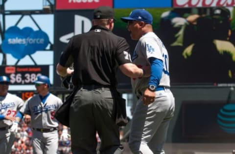 May 17, 2017; San Francisco, CA, USA; Umpire Mike Muchlinski (76) holds back Los Angeles Dodgers manager Dave Roberts (30) as both benches clear during the third inning of the game against the San Francisco Giants at AT&T Park. Mandatory Credit: Ed Szczepanski-USA TODAY Sports