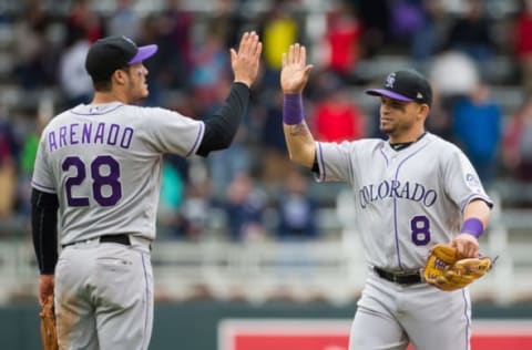 May 18, 2017; Minneapolis, MN, USA; Colorado Rockies third baseman Nolan Arenado (28) and outfielder Gerardo Parra (8) celebrate the win after the game against the Minnesota Twins at Target Field. Mandatory Credit: Brad Rempel-USA TODAY Sports