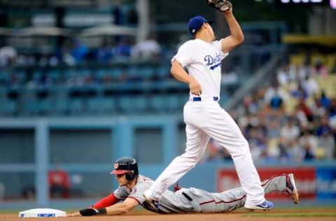 June 6, 2017; Los Angeles, CA, USA; Washington Nationals shortstop Trea Turner (7) steals second ahead of Los Angeles Dodgers shortstop Corey Seager (5) in the first inning at Dodger Stadium. Mandatory Credit: Gary A. Vasquez-USA TODAY Sports