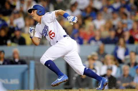 Jun 9, 2017; Los Angeles, CA, USA; Los Angeles Dodgers catcher Austin Barnes (15) runs after he hits a two-run RBI single in the third inning against the Cincinnati Reds at Dodger Stadium. Mandatory Credit: Gary A. Vasquez-USA TODAY Sports