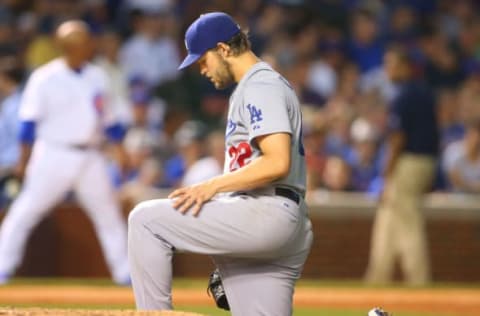 Jun 22, 2015; Chicago, IL, USA; Los Angeles Dodgers starting pitcher Clayton Kershaw (22) kneels during a delay of game against the Chicago Cubs at Wrigley Field. Mandatory Credit: Caylor Arnold-USA TODAY Sports